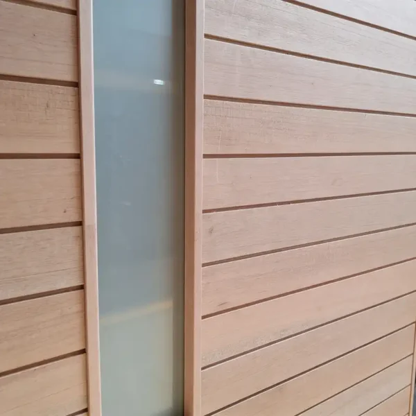 horizontal slatted wooden pivot door up close to show detail of the door